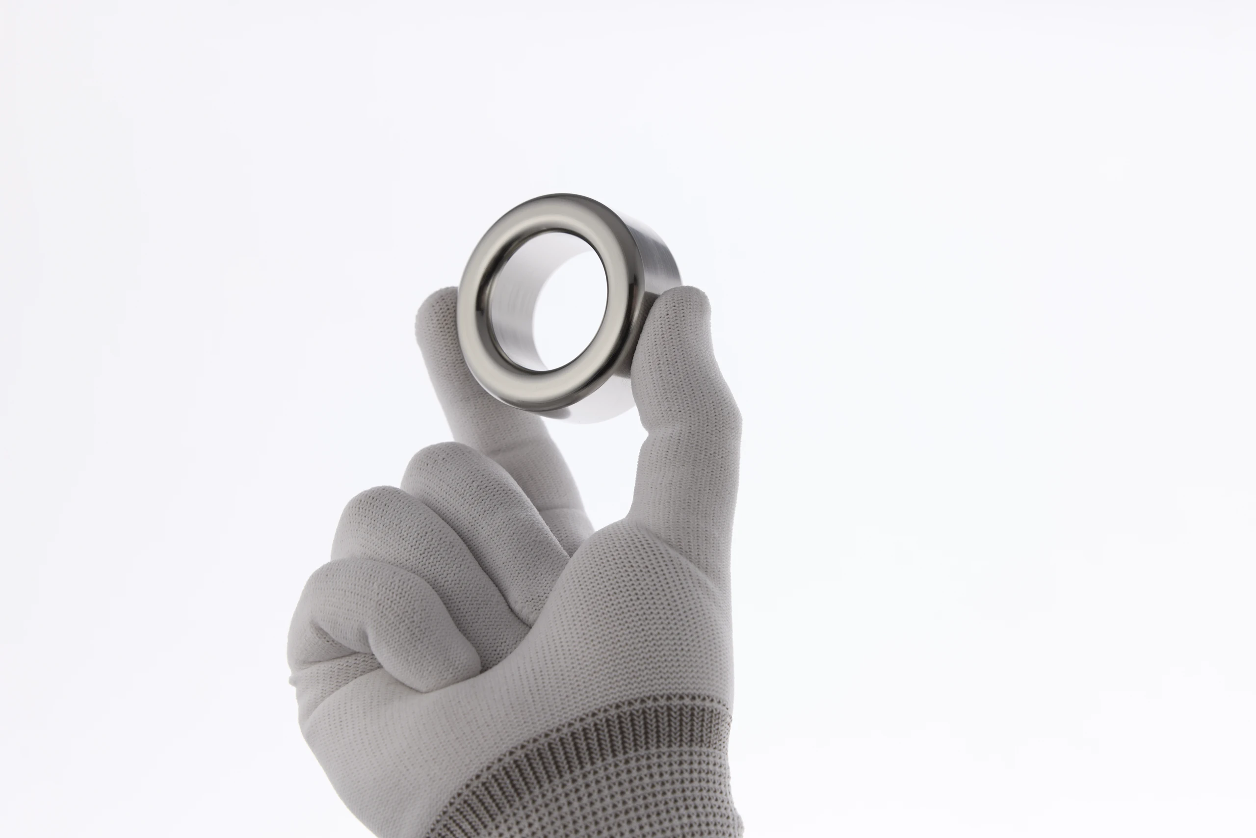 Gloved hand holding a machined wheel from a Type SB edition